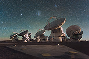 The Atacama Large Millimeter/submillimeter Array (ALMA) by night, under the Magellanic Clouds