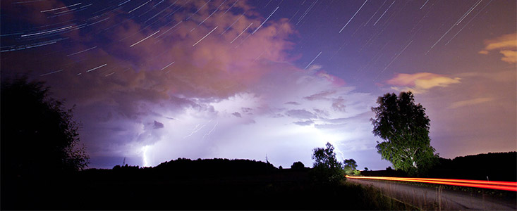 The constellation of Cassiopeia over a thunderstorm